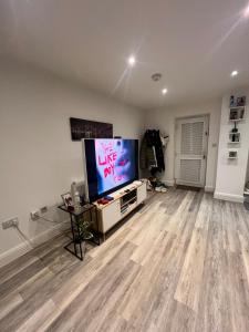 an empty living room with a flat screen tv at One bed flat in Sunny Southend! in Southend