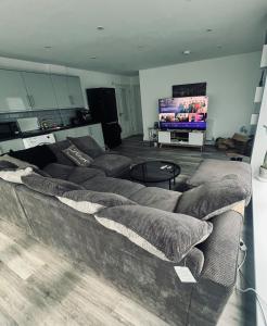 a living room with a couch and a flat screen tv at One bed flat in Sunny Southend! in Southend