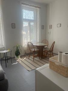a living room with a table and chairs and a window at Na Mahlerce in Jihlava +15 photos