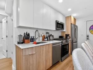 a kitchen with a sink and a stove top oven at 4BR 3Bath Game Room Harvard MIT Apt in Cambridge