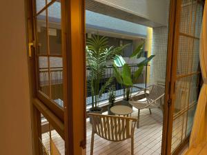 a room with a balcony with a table and chairs at illi Mia Kinshicho in Tokyo