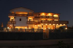 a large building with lights on it at night at Hotel Alexandros in Ammoudia