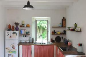 a kitchen with a sink and a refrigerator at Old Mill in Asturias in Llares