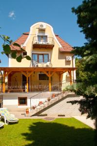 una casa grande con una escalera delante de ella en Apartments Yowan, en Hévíz