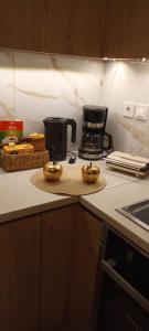 a kitchen counter with a coffee pot on a counter top at Kalomiris Thea Suite in Archanes +30 photos