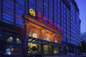 a building with a sign on the front of it at Xinhai Jinjiang Hotel in Beijing