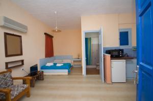 a living room with a bed and a kitchen at Gialos Studios & Apartments in Ierapetra