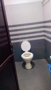 a bathroom with a toilet with blue and gray stripes at HOTEL OM VADODARa in Vadodara +22 photos