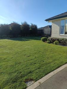 a yard of a house with a green lawn at Brightwater Beauty in Brightwater +4 photos