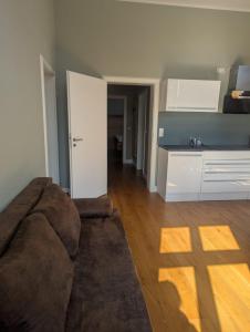 索林根Gästehaus LeLo 6的客厅里有一张沙发和一个厨房