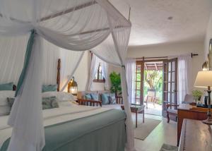 a bedroom with a bed with a canopy at Breezes Beach Club and Spa in Bwejuu +53 photos