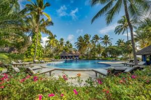 a pool at the resort with palm trees and flowers at Breezes Beach Club and Spa in Bwejuu