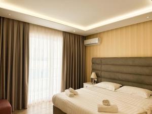 a hotel room with two beds with towels on them at Luna Rooms in Golem +61 photos
