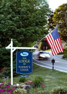 a sign with an american flag next to a street at The Lodge at Turbat's Creek in Kennebunkport