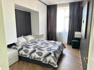 a bedroom with a bed and a large window at 2 х комнатная квартира in Baku