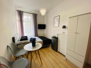a bedroom with a bed and a table and chairs at Dom gościnny Jarek in Rowy