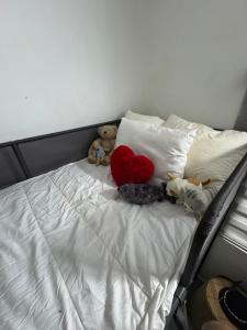 a group of stuffed animals sitting on a bed at Cozy Nature Homestay in Kuala Lumpur
