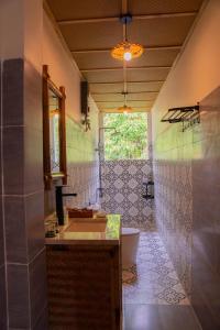 a bathroom with a sink and a toilet at Forest Home Phú Quốc in Phu Quoc