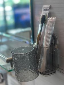 a cup with a toothbrush and a tooth paste at The Rose House-Lakeview Long Bien in Hanoi +11 photos