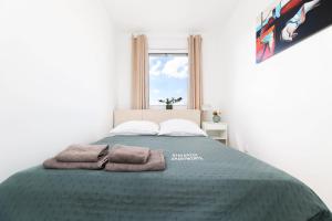 a bedroom with a bed with two towels on it at Apartament Brzeziny by Stay&Rest - szybki dojazd i parking in Czechowice-Dziedzice