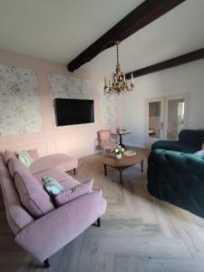 a living room with a couch and a table at Gîte L'Apothicaire in Montaigu-Vendée