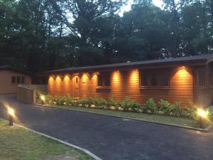 a house with lights on the side of it at Shellow Lane Lodges in Congleton