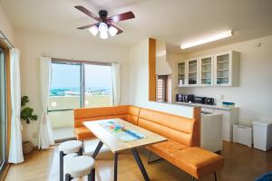 a living room with a couch and a table at kafuulivimg nagahama in Yomitan