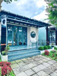 a building with a set of stairs in front at Gilan Boutique Hotel in Tân Phú