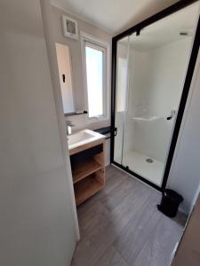 a bathroom with a sink and a shower at Camping des Papillons in Lalizolle +55 photos