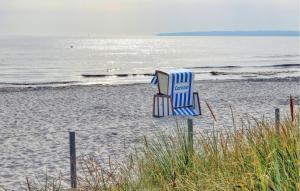 a blue and white chair sitting on the beach at Cozy Apartment In Altenkirchen With Wifi in Altenkirchen