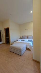 a bedroom with two beds and a flat screen tv at Casa do Cruzeiro in Alvações do Corgo +38 photos