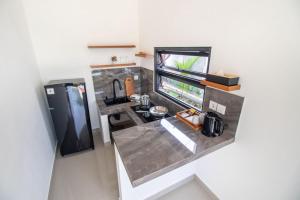 an overhead view of a kitchen with a sink and a refrigerator at Umanisa Villas in Gianyar