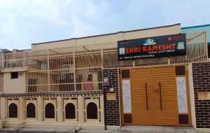 a building with orange doors and a sign on it at Shri Ramesht Paying Guest House, Ayodhya Dham, India in Ayodhya