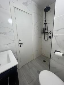 a bathroom with a shower and a toilet and a sink at Hadas in the desert in Yeroẖam