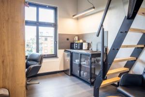 a room with a staircase and a desk and a chair at MOTTO Hotel Gdańsk Riverside OLD TOWN in Gdańsk
