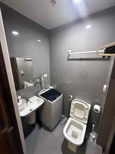 a small bathroom with a toilet and a sink at Makati Luxury Hotel Room Balcony Air Residence in Sampong