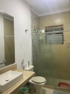 a bathroom with a toilet and a glass shower at Pousada Girassol in Rio de Janeiro +34 photos