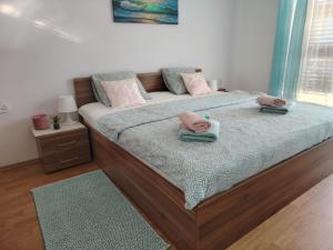 a bedroom with a bed with two pillows on it at Apartments Xenia Krk in Krk