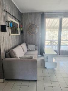 ein Wohnzimmer mit Sofa und Tisch in der Unterkunft Maison sur vue montagne in Canet-en-Roussillon