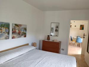 a bedroom with a bed with two pictures on the wall at Il Glicine sul Lago in Tronzano Lago Maggiore