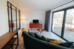 a living room with a couch and a tv at The Observatory Annexe in Dorking