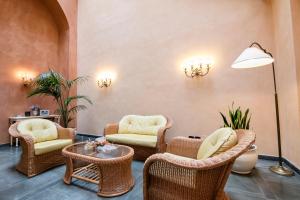 a lobby with wicker chairs and a table at Albergo Delle Notarie in Reggio Emilia