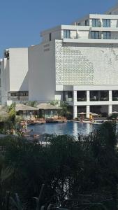 a building with a swimming pool in front of a building at Long Beach, İskele, Grand Sapphire Resort - Pool View Luxury Studio in Paralimni