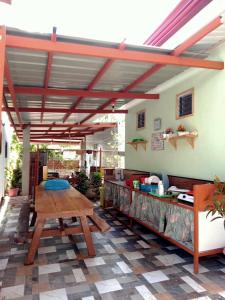 a patio with a wooden table and awning at Cupids Cabin Beach in San Francisco +17 photos