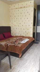 a large bed in a room with a wall at PG - Sudha sadan in Lucknow