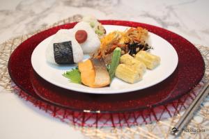 a plate of sushi on a red plate at Piccola casa awaji in Awaji