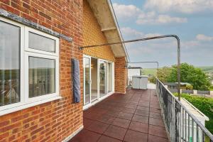 a balcony of a brick building with windows at Saltdean Sea Haven in Saltdean
