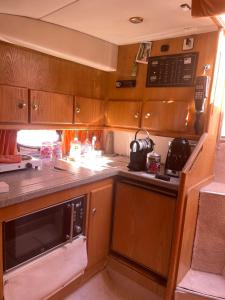 an rv kitchen with a stove and a microwave at Logement insolite French Riviera avec parking in Antibes