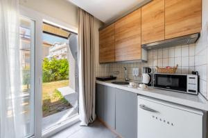 a kitchen with a sink and a microwave at Soul House Kuşadası in Kuşadası
