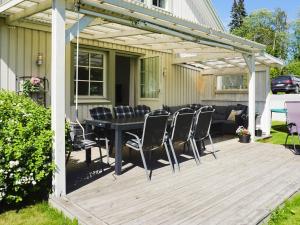 a patio with a table and chairs on a deck at 4 star holiday home in Sollentuna in Sollentuna